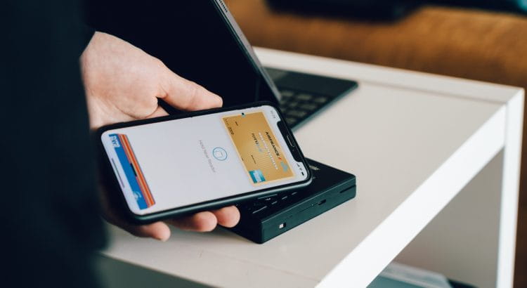 Eine Hand hält ein Smartphone mit einer virtuellen Kreditkarte.