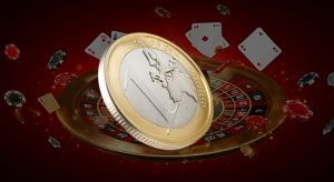 Eine 1-Euro-Münze liegt auf einem Smartphone mit einer Casino-App.